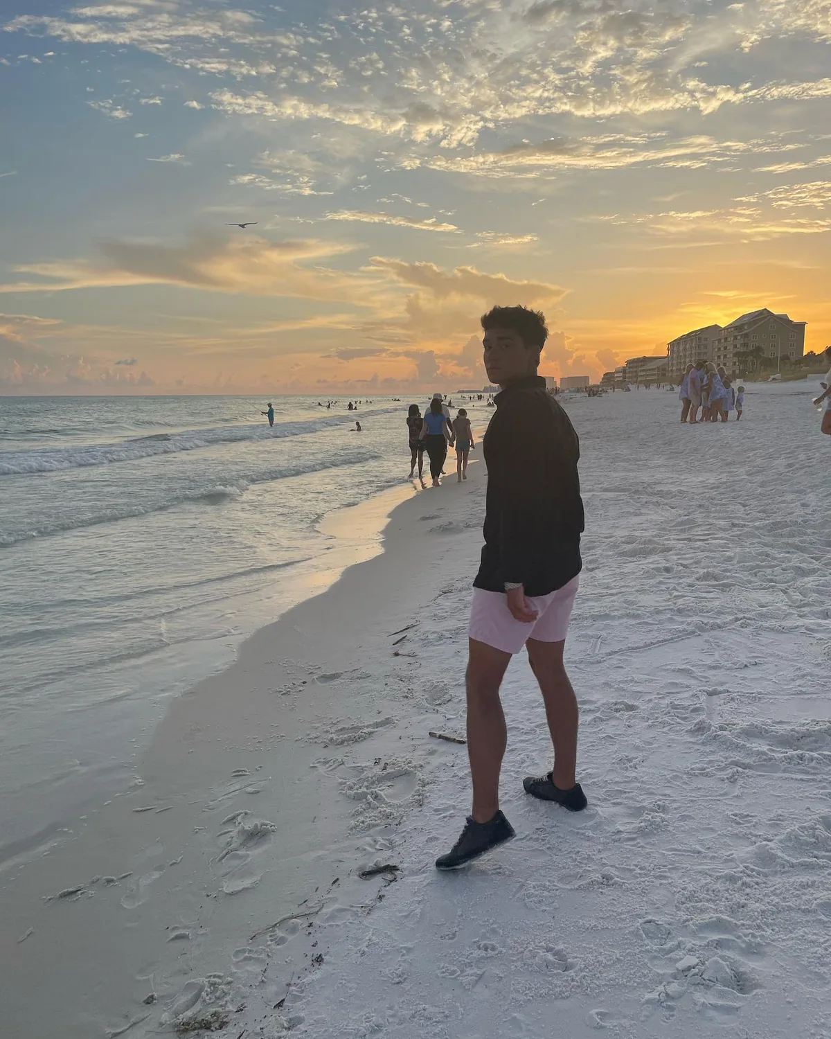 Alex standing on a beach in the evening