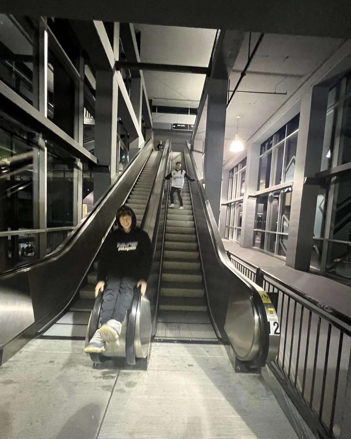 Two friends on escalators