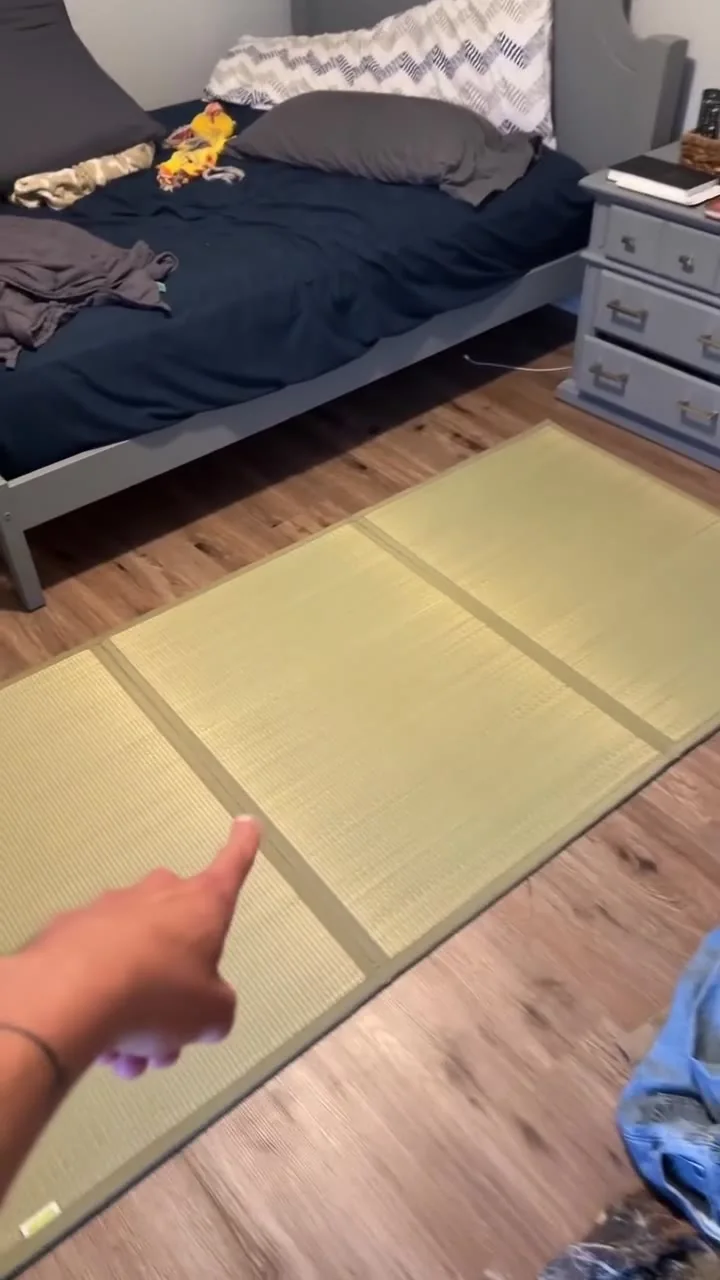 Still from a historical video showing an experiment with a floor sleeping setup