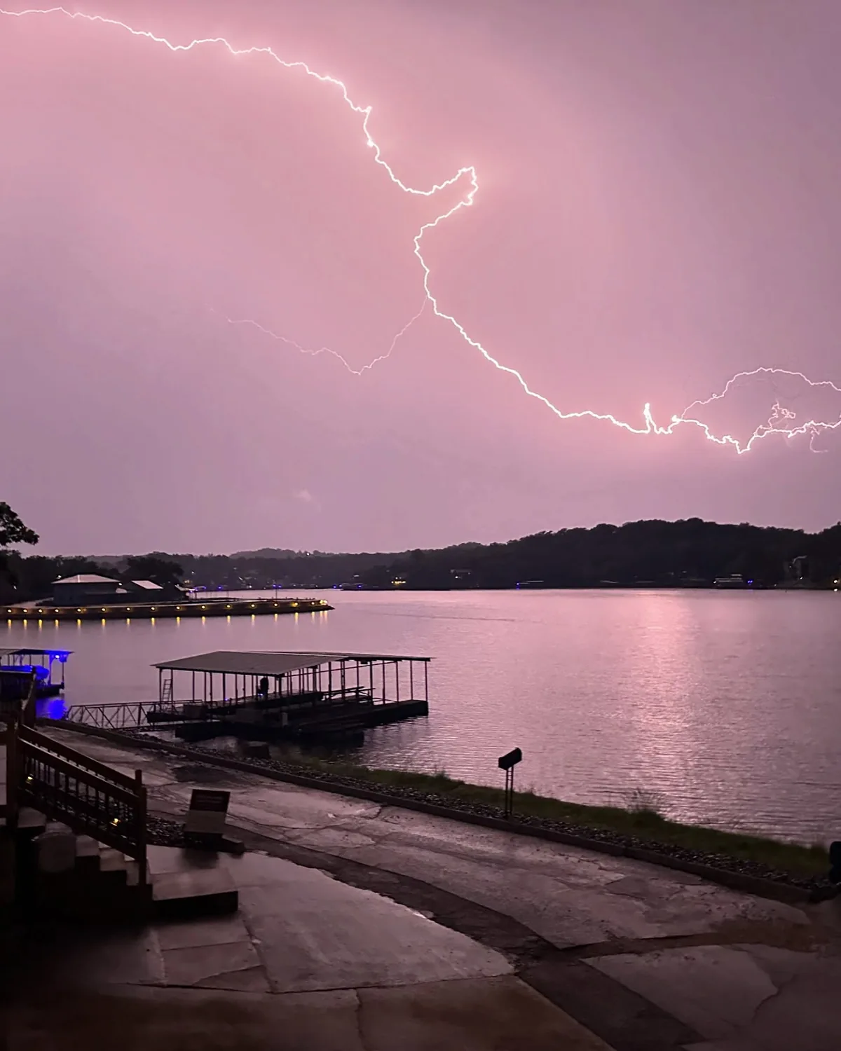 Lightning across a pink sky above the lake