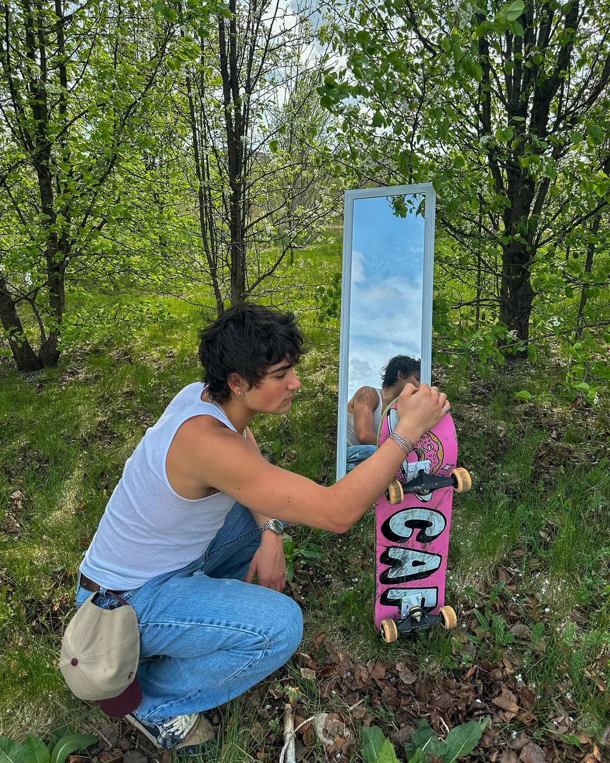 A woodland mirror photograph with a skateboard