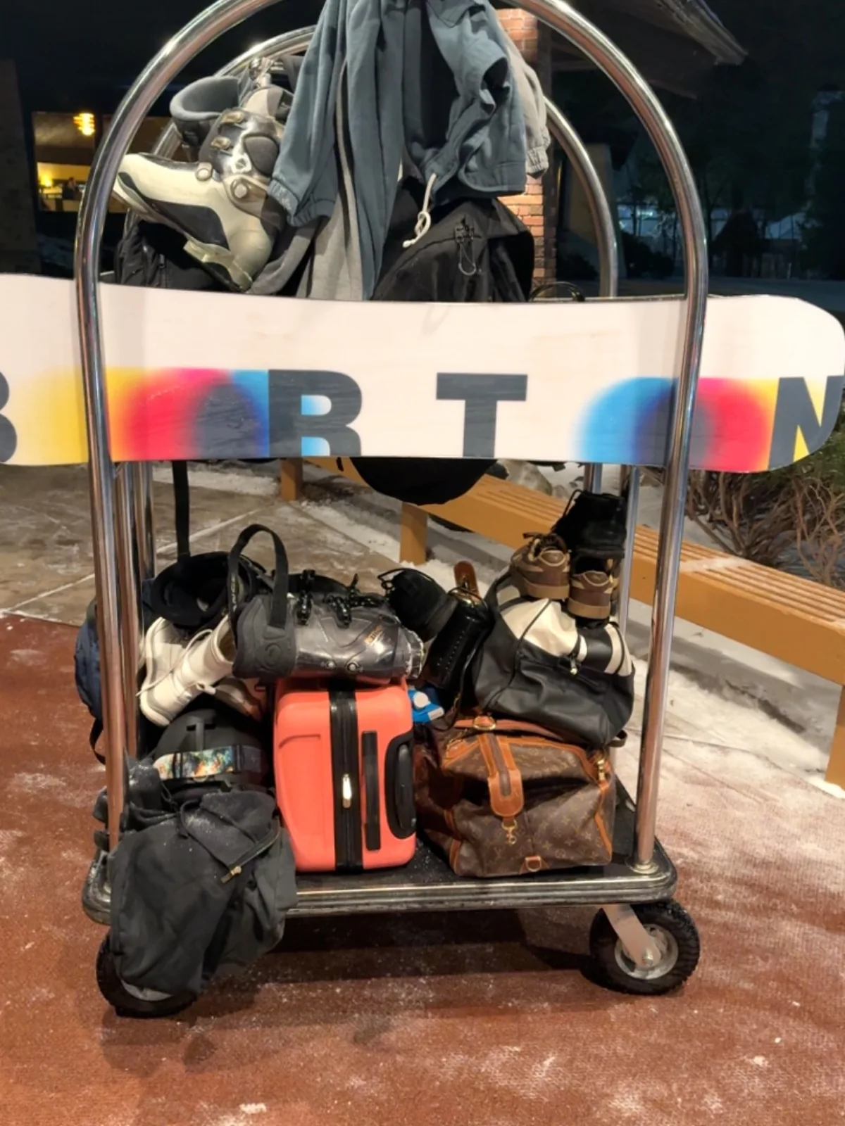 Snowboard, boots, bags and luggage on a trolley