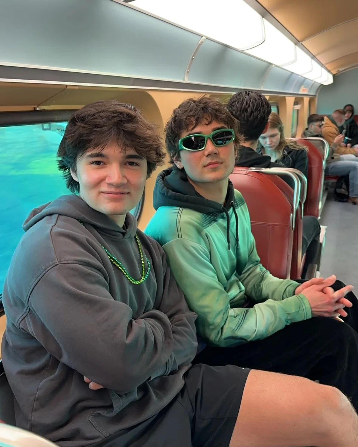 Friends seated together on a train